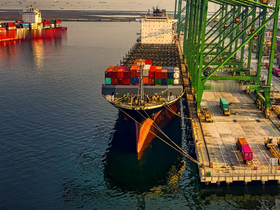 A container ship at a port quay, seen from the air
